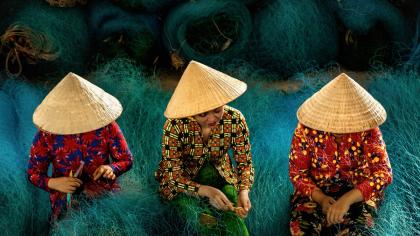 Women repair fishing nets in Bac Lieu City, Vietnam.